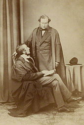 Sir Charles Jasper Selwyn (standing) was the umpire for the fifth time. Selwyns.jpg