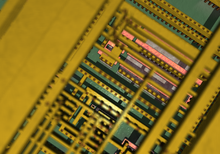 Virtual detail of an integrated circuit through four layers of planarized copper interconnect, down to the polysilicon (pink), wells (greyish), and substrate (green) Siliconchip by shapeshifter.png