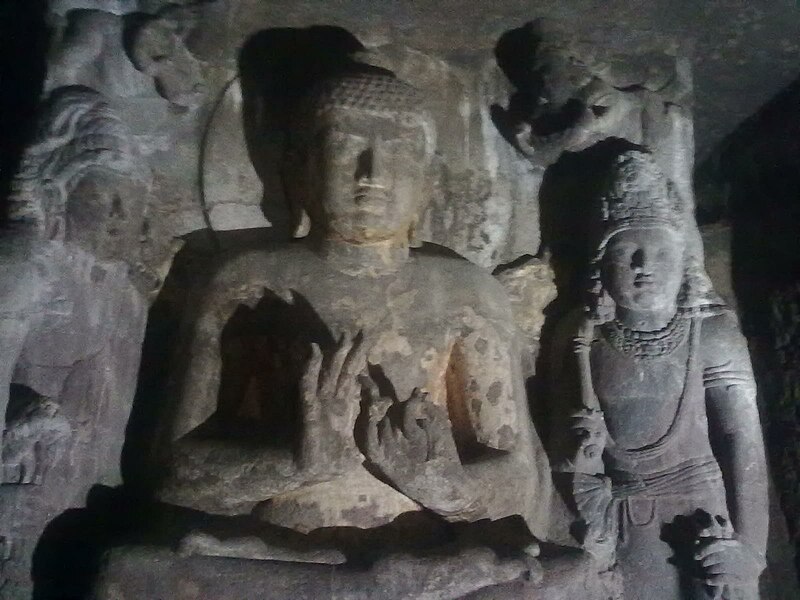 File:Stone Buddha in padmasana with two other deities around at Ajanta Caves.jpg