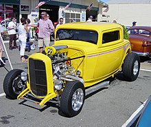 3-window highboy Deuce coupe with a traditional chop--dropped front axle, sidepipes, bugcatcher scoop (with Mooneyes cover) over dual quads on a tunnel ram--as well as less-traditional shaved door handles and disc brakes ThreeWindowCoupeHotrod6791.jpg