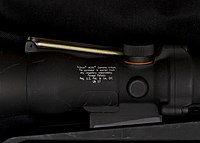 Trijicon rifle scope with reference to 1 John 1:7, "But if we walk in the light, as he is in the light, we have fellowship with one another, and the blood of Jesus, his Son, purifies us from all sin." Trijicon rifle scope with Bible verse.jpg