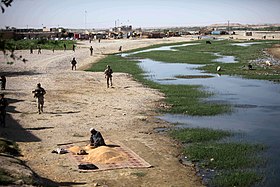 Marines with 1st Battalion, 2nd Marine Regiment, patrol the Musa Qala District Center in 2010. USMC-100806-M-9746B-011.jpg