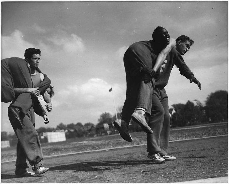 File:Victory Corps. The correct method of carrying a wounded comrade by some of the boys in the "Commando" course in... - NARA - 196330.tif