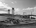 View of Tasman Bridge under construction with Hobart pontoon bridge still in place (1964) (16198893025).jpg