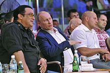 Seagal and Putin attending a Russian martial arts championship Aktior Stiven Sigal, Vladimir Putin i mnogokratnyi chempion mira po smeshannym edinoborstvam Fiodor Emel'ianenko - 2.jpeg
