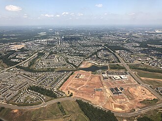 Aerial photographs of communities with cul-de-sac layouts in Loudoun County, Virginia 2019-07-19 13 00 41 View north along the Loudoun County Parkway (right) and Belmont Ridge Road (left) as they pass through Brambleton and Loudoun Valley Estates in Loudoun County, Virginia, viewed from an airplane which just took off.jpg