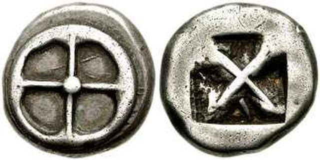 Athenian silver didrachm of "heraldic type" from the time of Peisistratos, 545–510 BC. Obverse: Four-spoked wheel. Reverse: Incuse square, divided dia