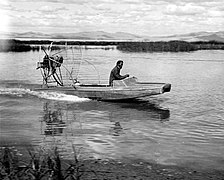 Airboat: propelled by a fan, there's nothing to tangle with vegetation that may be in the water. This one is from the 1940s; modern airboats are similar.