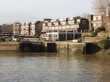 Brentford Dock lock gates and Justin Close Brentford Dock (estate) is a basin off the Thames, with modern housing around it.