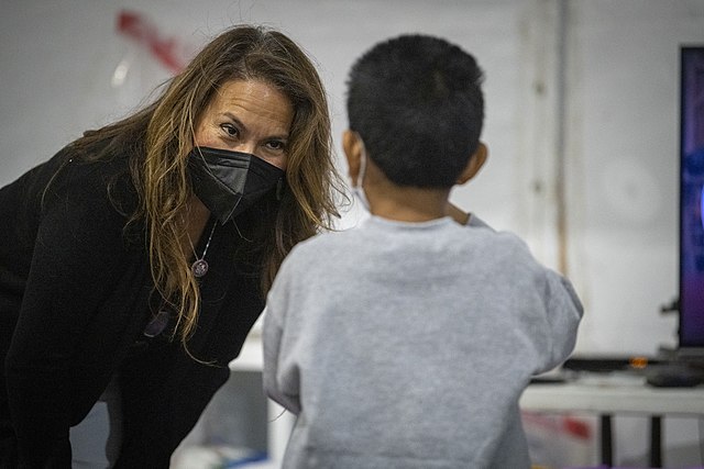 Escobar meets with a migrant child at the CBP processing center in Donna, Texas in May 2021.