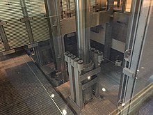 Pit of a hydraulic scenic elevator with metal grating on bottom. This elevator travels seven stories. Elevator hydraulic.jpg