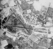 An aerial view of RAF Exeter airfield on 20 May 1944, showing the triangular layout of the runways and the encircling (light-coloured) perimeter track Exeter-20may44.jpg