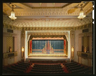 General interior view of the theater, 1979 GENERAL VIEW OF THE INTERIOR OF THE THEATER SHOWING THE PROSCENIUM CURTAIN (ORIGINAL), BOXES, AND PART OF THE SEATING AREA. - Anaconda Historic District, Washoe Theater, HABS MONT,12-ANAC,1-B-13 (CT).tif