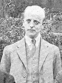 Black-and-white photographic portrait of a gentleman in a suit