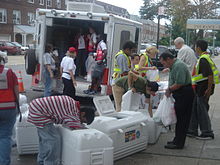 During the Queens blackout, Con Ed workers gave out bags of ice to people in Astoria. Giving out ice in Astoria 3.JPG