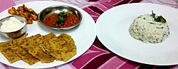 Thumbnail for File:Gobhi ka parantha served with tomato chutney, dahi and curd rice.jpg