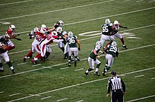 In his regular season debut on December 2, 2012, McElroy hands the ball off to running back Bilal Powell. Greg McElroy handoff to Bilal Powell.jpg