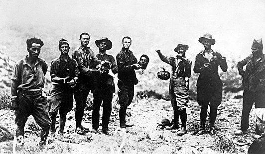 Spanish legionnaries in Morocco holding up the heads of Moroccans they have captured and beheaded during the Rif War.