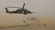 Fast-roping at a Combat Search and Rescue action, featuring a HH-60G Pave Hawk.