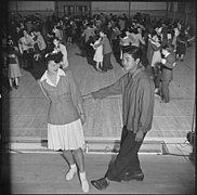 Heart Mountain Relocation Center, Heart Mountain, Wyoming. "Tubbie" Kunimatsu and Laverne Kurahara demonstrate some intricate jitterbug steps, during a school dance held in the high school gymnasium.