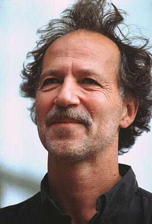 A profile image of Herzog with recent facial hair and wavy, unkept hair