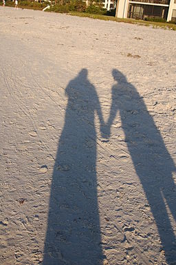 Holding Hands shadow on sand