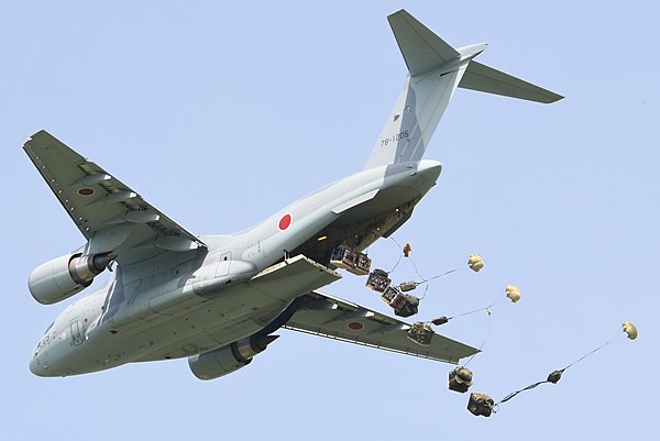 A Kawasaki C-2 military transport aircraft conducting an airdrop demonstration over Miho Air Base, 2018