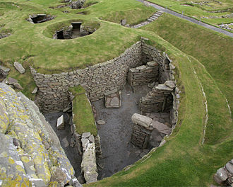The preserved ruins of a wheelhouse and broch at Jarlshof, described as "one of the most remarkable archaeological sites ever excavated in the British Isles". Jarlshof 20080821 - aisled roundhouse and broch.jpg