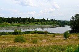 Tvenkinys nuo Aukštųjų Kaplių gyvenvietės