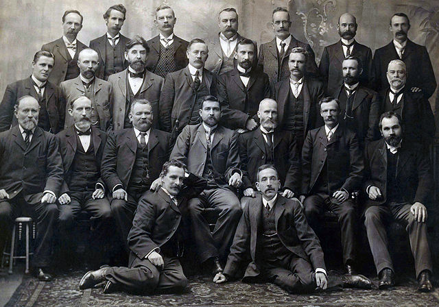 Group photograph of all Federal Labour Party MPs elected at the inaugural 1901 election, including Chris Watson, Andrew Fisher, Billy Hughes, and Fran