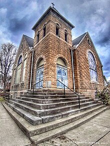 Photo of a church building, with stairs leading up to it