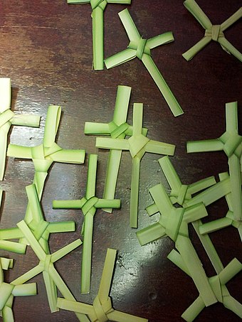 Small crosses woven from blessed palms are often distributed at churches on Palm Sunday.
