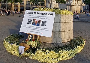 Flowers at Dam Square, Amsterdam after the shooting. The text reads "Attack on the freedom of press? No, an attack on his involvement with the Marengo trial!" Peter de Vries - Dam - Amsterdam 2021 (cropped).jpg