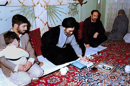 An Iranian family catering black tea for President and future Supreme Leader Ali Khamenei in their house, February 1987.