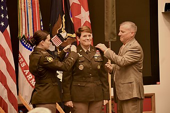 Lt. Gen. Maria Gervais' daughter, Cpt. Brandi Gervais, and husband, Christopher Gervais, pin Maria's stars on her service uniform during her promotion ceremony on June 21, 2021.