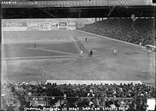 Ebbets Field with Green River ad visible on outfield wall, 1913 Ray Caldwell pitching in the first game at Ebbets Field, April 5, 1913.jpg