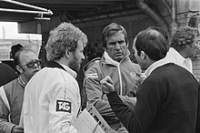 Williams team principal Frank Williams (right) talks with Carlos Reutemann (centre) during the practice session. Reutemann and Williams at 1981 Dutch Grand Prix.jpg