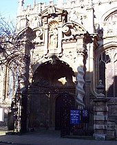 The south porch, designed by Nicholas Stone, viewed from the High Street. Bullet holes in the statue were made by Oliver Cromwell's troops. SMV Porch.jpg