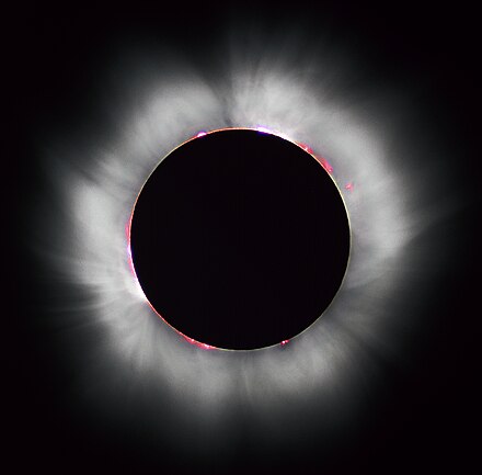 Solar prominences can sometimes be visible in red around the edges of the Sun during a total solar eclipse.