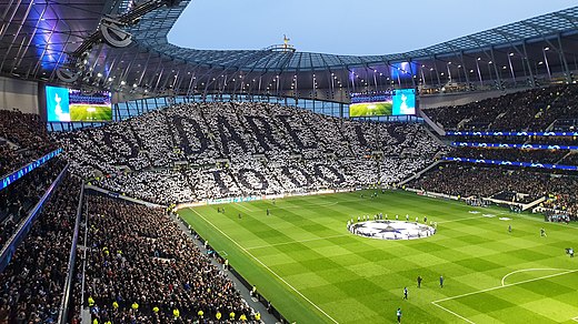 The South Stand, also known as the Park Lane end, before the UEFA Champions League quarter-final with Manchester City F.C. on 9 April 2019, with fans displaying the club motto 'To Dare Is to Do'.