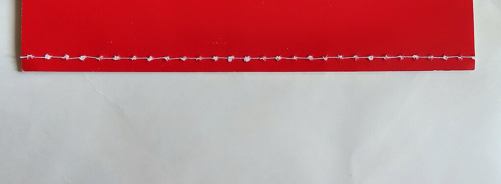 Traditional Chinese bookbinding for a red booklet