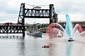 A Portland fire boat greets the USS Ingraham as she passes under the Steel Bridge during the 2006 Rose Festival Fleet Week