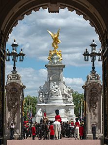 The Victoria Memorial, London, seen through the main entrance and gates of Buckingham Palace.