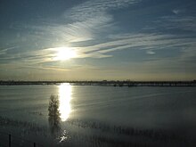 Flooded Yolo Bypass, February 2006. Interstate 80 runs along the causeway in the distance. Yolo Bypass.jpg