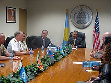 The state flags during a meeting between Patrick M. Walsh and President Johnson Toribiong in 2011 Adm. Walsh addresses Palau President Toribiong (5892976584).jpg