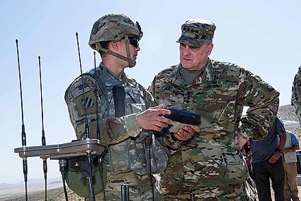 Chairman of the Joint Chiefs of Staff General Mark Milley receives a briefing from a cyber soldier at the Fort Irwin National Training Center.