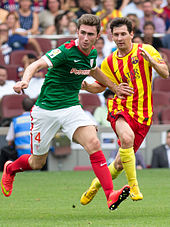 Aymeric Laporte from Athletic Bilbao (left) and Lionel Messi from FC Barcelona playing by choice in change kits in their respective Basque and Catalan regional flag colours (2014) - their usual kits do not clash Aymeric Laporte and Leo Messi.jpg