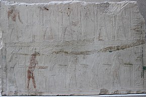 Relief showing two rows of people with hieroglyphic signs