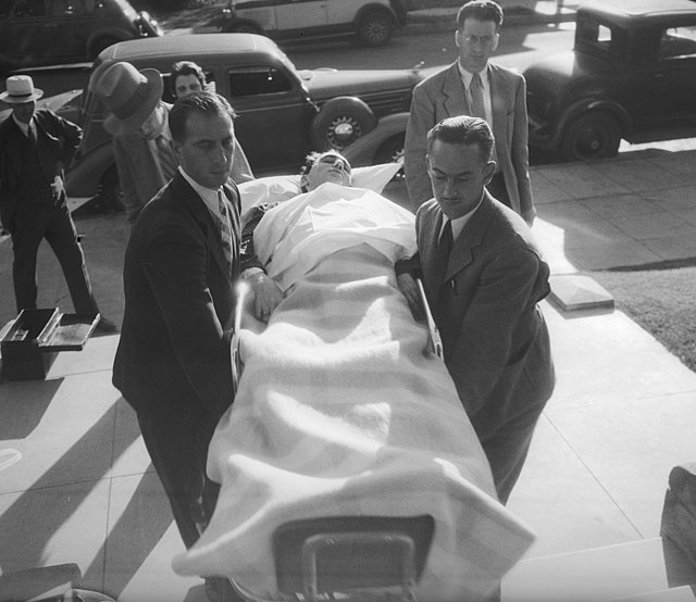 Berkeley being carried into his trial on a stretcher, September 1935