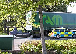 A rear-end collision in Yate, near Bristol, England, in July 2004. The car failed to stop when the semi truck stopped at a roundabout. The car's bonnet can be seen deep under the rear of the lorry. Car.accident.arp.750pix.jpg